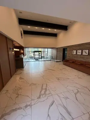 an empty lobby with a marble floor and a large room at Vibrant 1 Bedroom Condo Apt in Toronto