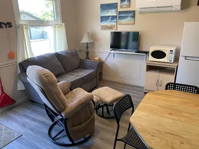 a living room with a couch and a table at The Maples Cottages in Port Elgin in Port Elgin