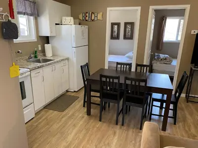 a kitchen and dining room with a table and chairs at The Maples Cottages in Port Elgin in Port Elgin