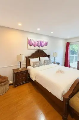 a bedroom with a large bed and two lamps at Spacious 5-Bedroom House in Thornhill in Vaughan