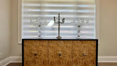 a dresser with three candles on top of it in a room with a window at Luxury 4BR Retreat with Pool, Piano, Spa & Games in Mississauga
