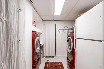 a laundry room with a washer and dryer at 4 Bedroom Stoney Creek Nature Oasis Sauna, Games & Luxury Comfort in Hamilton