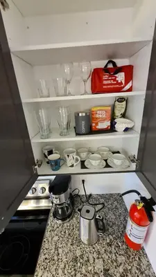 a kitchen counter with dishes and glasses on shelves at Newly constructed 3-Bedroom-Hyde Park- close to UWO and Hospital in London