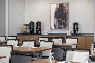a restaurant with tables and chairs and a picture on the wall at Hyatt Place Toronto Airport in Toronto