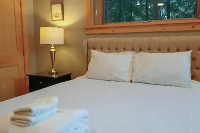 a bedroom with a bed with towels on it at Waterfront 3 Bedroom Home in Port McNicoll