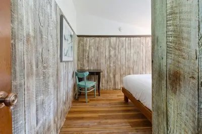 a bedroom with a bed and a chair and a desk at Stunning Mountain Getaway with Open Concept Design in Blue Mountains
