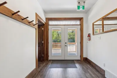 a hallway with a white door and a window at 8 BR Luxury Swiss Style Chalet w Hot Tub in Blue Mountains