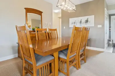 a dining room with a wooden table and chairs at Fore Seasons Escape with Golf in Backyard in Blue Mountains