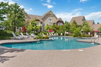 a swimming pool with chairs and a house at Fore Seasons Escape with Golf in Backyard in Blue Mountains
