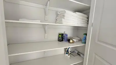 a closet with white shelves and towels at Grand Woodstock Luxe House 4BR in Woodstock
