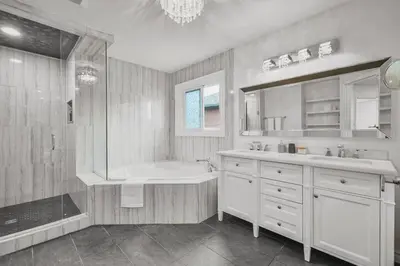 a bathroom with a tub and a sink and a shower at Luxe 4BR Retreat w Heated Pool Hot Tub and BBQ in Whitby