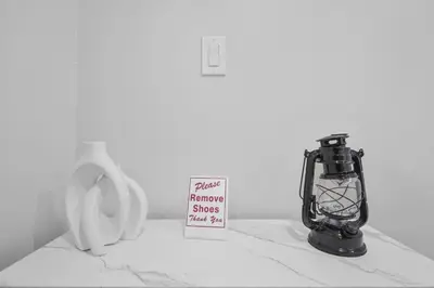 a black lantern next to a sign next to a urinal at Stylish 3 BR Apt with Free Parking, Wifi and Patio in Whitby