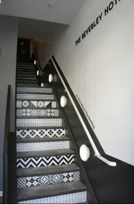 a set of stairs with a sign on the wall at The Beverley Hotel in Toronto