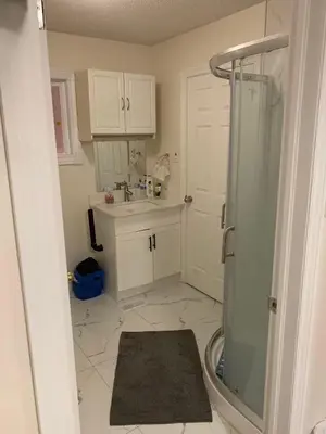a small bathroom with a shower and a sink at Private comfortable M1 bedroom in Mississauga