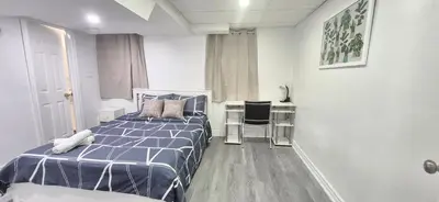 a bedroom with a bed and a desk with a chair at Pacific Mall Bright & Cozy Rooms with Privated Bathrooms in Toronto