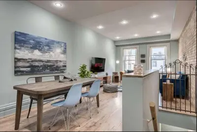 a kitchen and dining room with a wooden table and chairs at Modern Industrial Suite w Private Patio - The Roland in Toronto