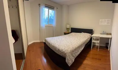 a bedroom with a bed and a desk and a window at Private bedroom 202 in Mississauga