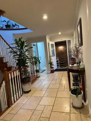 a hallway with potted plants and a staircase in a house at Private bedroom 202 in Mississauga