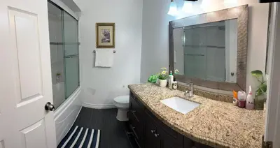 a bathroom with a sink and a toilet and a mirror at Private bedroom 202 in Mississauga