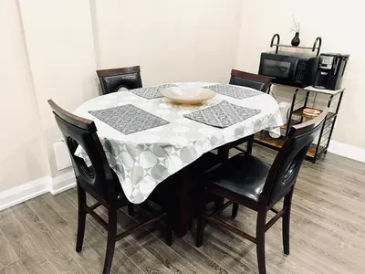 a dining room table with a white table cloth on it at Heaven on Earth in Ajax
