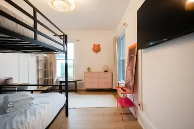 a bedroom with a bunk bed and a desk at County Cove - Newly Renovated Century Home in Carrying Place