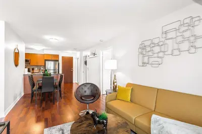a living room with a couch and a table at Luxe 3BR 2 Bath Condo Steps from Square one Mall in Mississauga