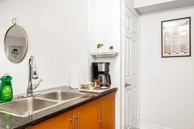 a kitchen with a sink and a counter top at Luxe 3BR 2 Bath Condo Steps from Square one Mall in Mississauga