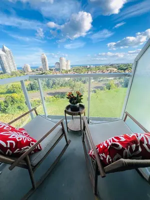 two chairs on a balcony with a view of the city at Lakeview in Toronto