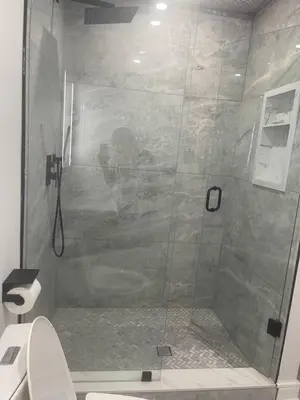 a glass shower in a bathroom with a toilet at Self contained lower level 1 Bedroom apartment in Oshawa