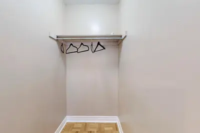 a room with a white wall and a shelf with three glasses at Charming 4-bed Home Away From Home in Brampton, ON in Brampton
