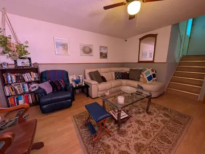 a living room with a couch and a table at Cozy home away from home, close to hospital, college, and university with free parking in Peterborough