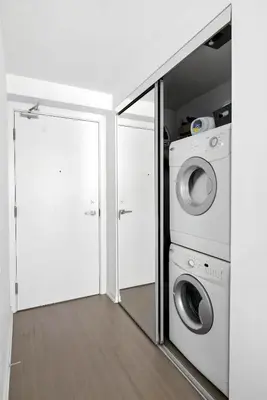 a laundry room with a washer and dryer at Modern Studio Retreat in Downtown Toronto in Toronto