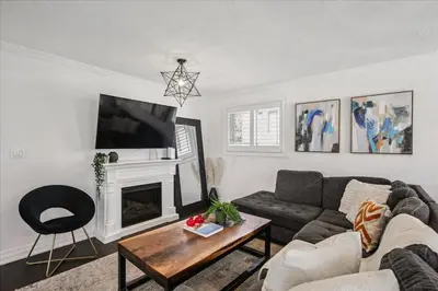 a living room with a couch and a fireplace at Bright 3-BDRM House, Family Home & Parking, YYZ Airport in Mississauga