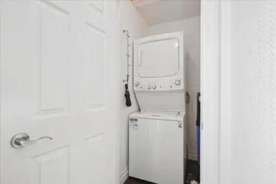 a kitchen with a washer and dryer in a room at Bright 3-BDRM House, Family Home & Parking, YYZ Airport in Mississauga