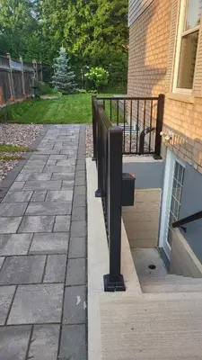 a patio with a fence next to a house at Cozy 2 Bedroom Suite, 5 mins from Thermea Spa in Whitby