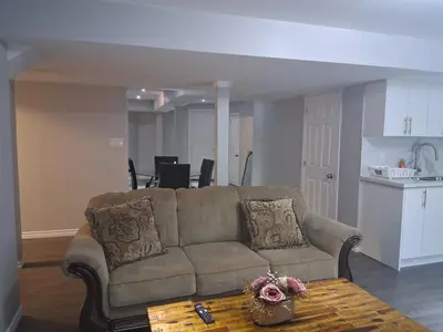 a living room with a couch and a table at Beautiful&Spacious 2 Bedroom Basement Family Suite in Bradford