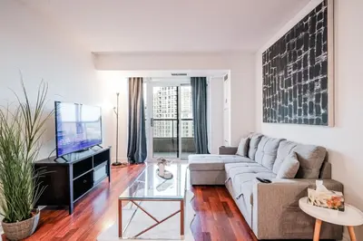 a living room with a couch and a tv at Elegant 2BR 2BA Condo Heart of Mississauga SQ1 in Mississauga