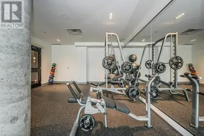 a gym with two treadmills and two machines at Hydropool Spa Hot Tub Bowling Alley Patio BBQ Games in Kitchener