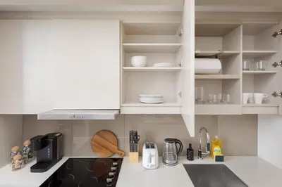 a kitchen with white cabinets and a sink at Chic 1BR King Suite TOs Entertainment District in Toronto