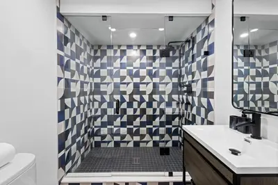 a bathroom with a shower with a toilet and a sink at Modern Parkdale Getaway 1-Bedroom Parking in Toronto