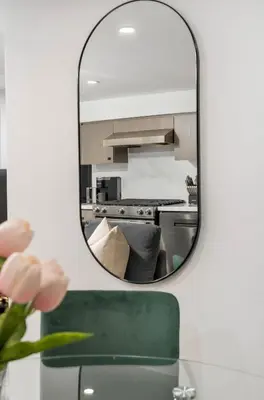a mirror hanging on a wall in a kitchen at Modern 1-BR Condo with Parking in Downtown Toronto in Toronto