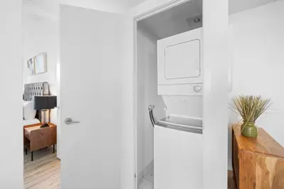 a kitchen with white walls and a refrigerator at Modern Lakefront Esc Stylish 2BR Condo with Patio in Toronto