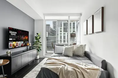 a bedroom with a bed and a large window at Gorgeous 2BR in Downtown Toronto w City Views in Toronto