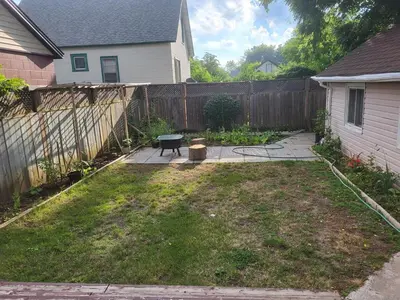 a backyard with a fence and a bench in the yard at 75 inch high mud house with separate entrance and exit, one bedroom, one living room, private bathroom, there is a cute cat, a few minutes walk to many restaurants, 8 minutes drive to the big waterfall in Niagara Falls