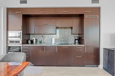 a kitchen with brown cabinets and a counter top at Panoramic 2 Bedroom 2 Bathroom Condo Sheppard Metro North York Toronto in Toronto