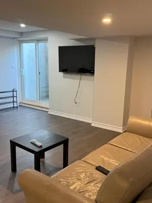 a living room with a couch and a table at Comfy Basement Suite in Quiet Neighbourhood in Whitby