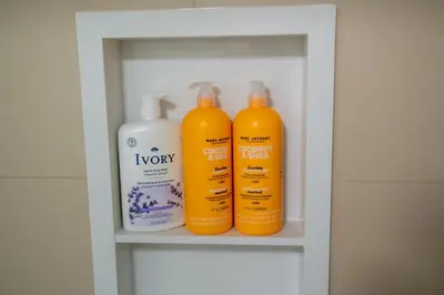 three bottles of shampoo and conditioner on a shelf at Studio Apartment B - Full Kitchen - Cozy and Modern in Brampton
