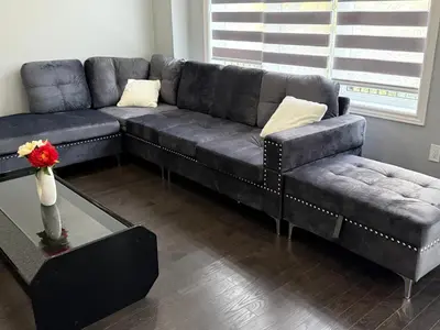a living room with a black couch and a table at masters bet room in Whitby