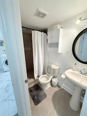 a bathroom with a toilet and a sink at Modern & cozy one Bedroom Basement Suite with Kitchen and parking- sleeps 4 in Mississauga