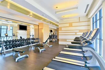 a gym with rows of treadmills and machines at Luxury 1BR Suite w Skyline City Views - The Roland in Toronto